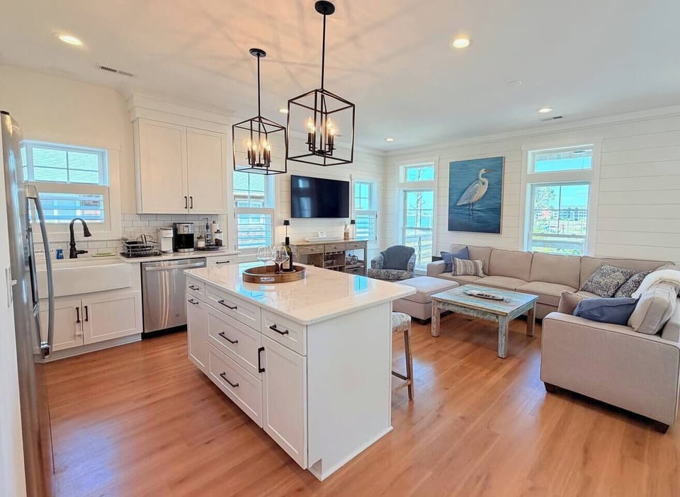 Take in calming water views in the bright main living area. TV | Soundbar | Games | Bar
