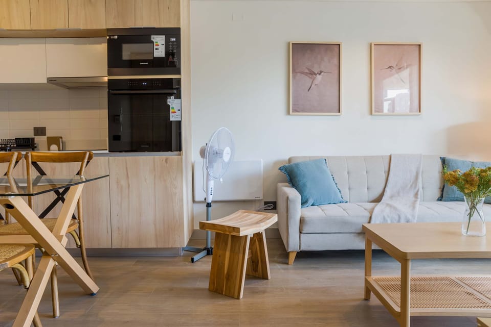 Cozy living area with modern amenities and stylish decor, perfect for relaxation in a compact studio setting.