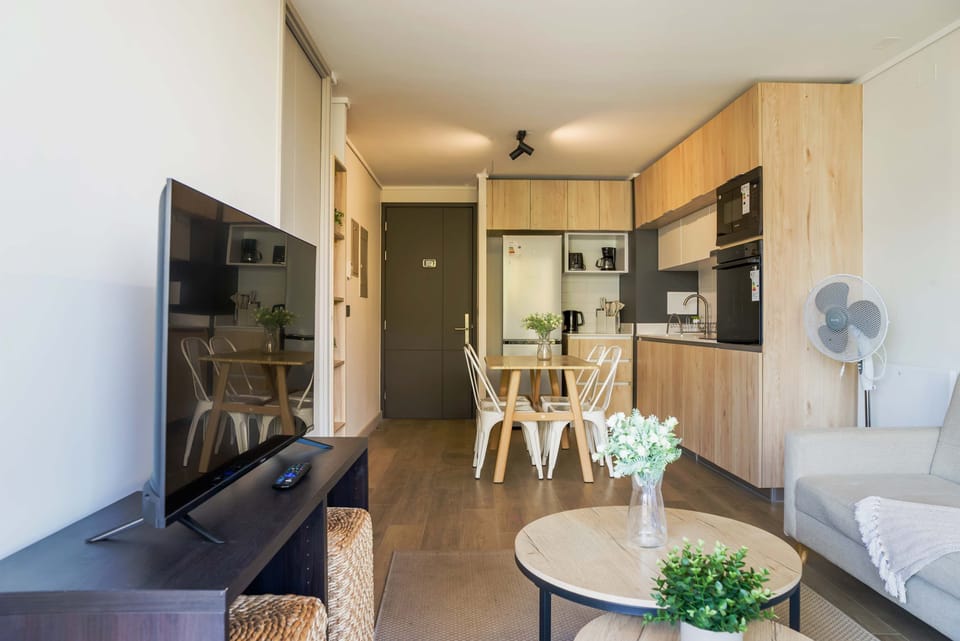 Enjoy a cozy and modern living space with a fully equipped kitchen and dining area, perfect for relaxing after exploring the city.