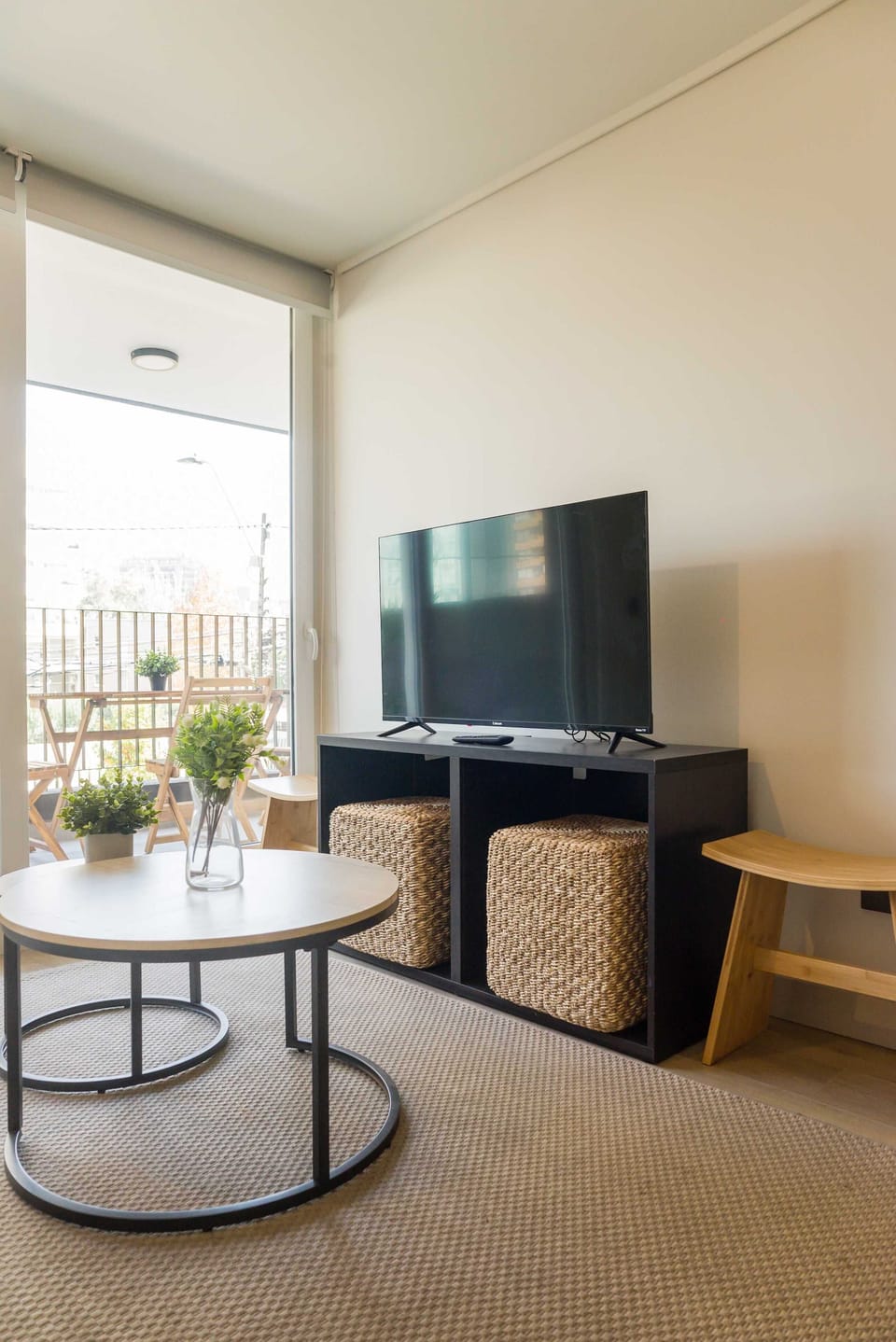 Relax in this cozy living area with a TV and enjoy the fresh air from the charming balcony seating.