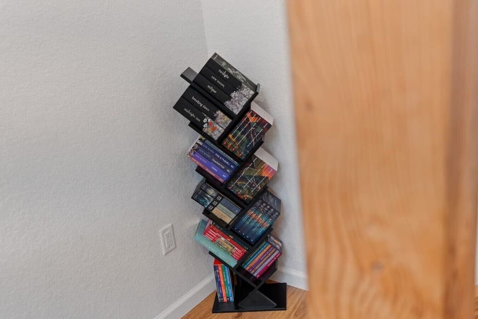 Adding to the home’s warm and welcoming feel, a curated selection of books lines the walkway leading upstairs!