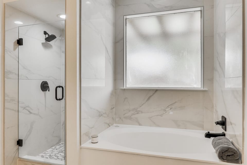 A luxurious bathroom with a walk-in shower and deep soaking tub—perfect for a refreshing shower or a relaxing soak after a long day.
