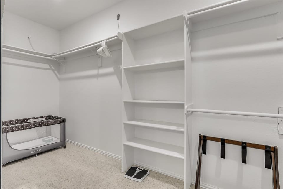 A spacious walk-in closet offering ample storage and organization, keeping everything neat, accessible, and stress-free.