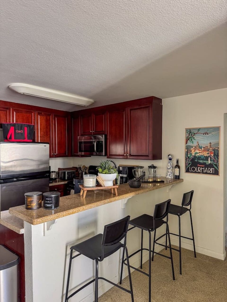Kitchen counter with breakfast bar seating, perfect for casual meals or a quick morning coffee before heading out.