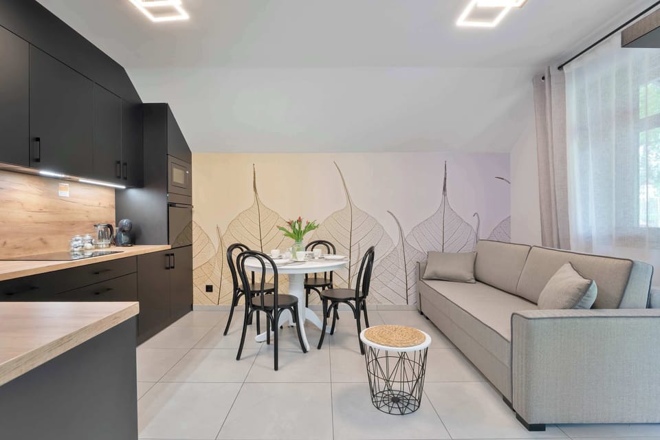 An open-plan kitchen and living room with modern furnishings and soft neutral tones.