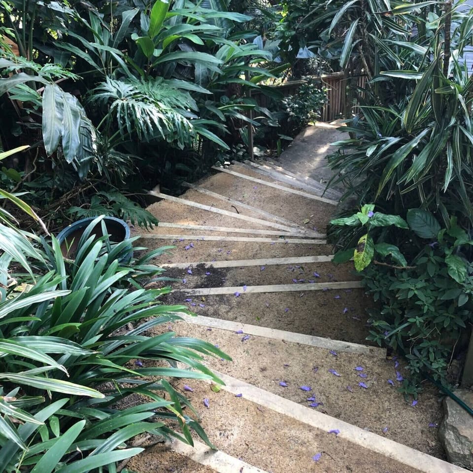 Stairs lead you to a path to the beach.