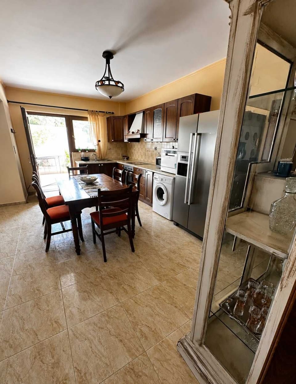 Wide-angle view of the kitchen and dining area with rustic charm