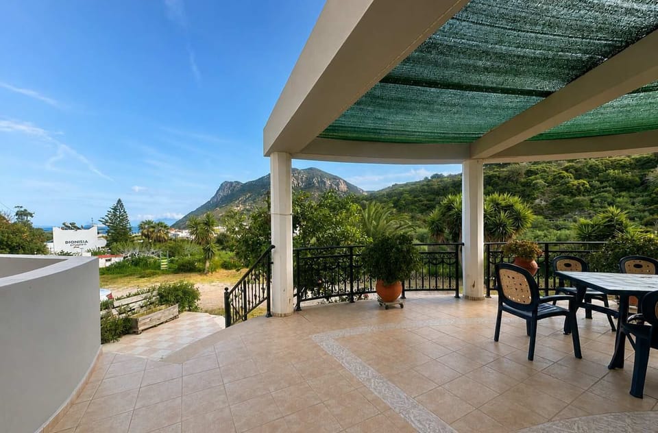 Spacious covered terrace with outdoor seating and scenic mountain views