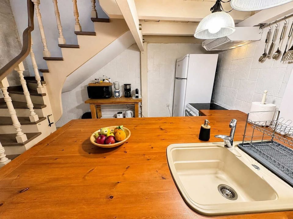 
Modern kitchen with a spacious wooden countertop, perfect for cooking together