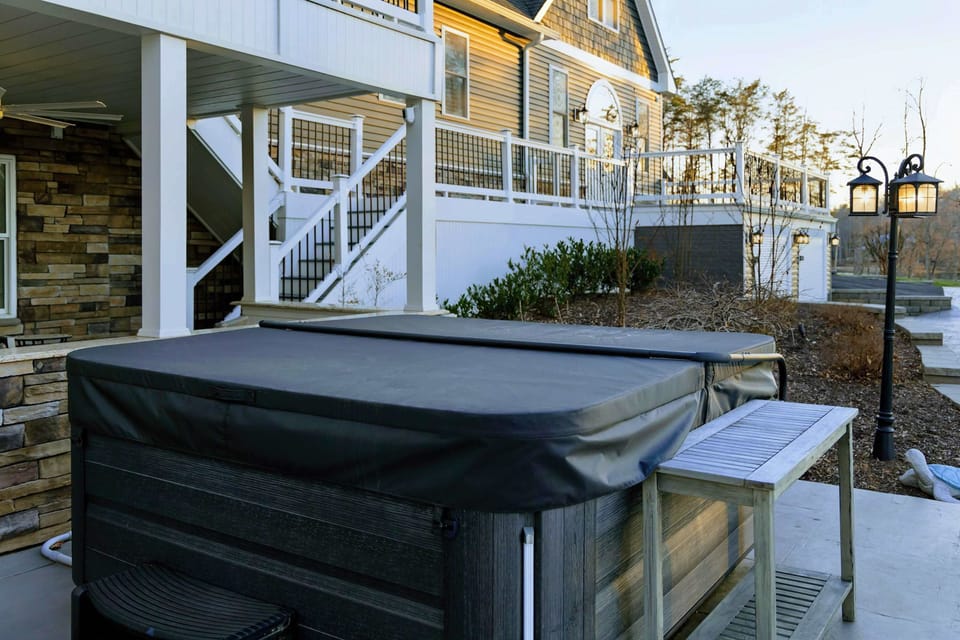 Hot Tub - A wood-trimmed soaker on the lower patio, tucked below the deck for quiet evenings after a day on the water.