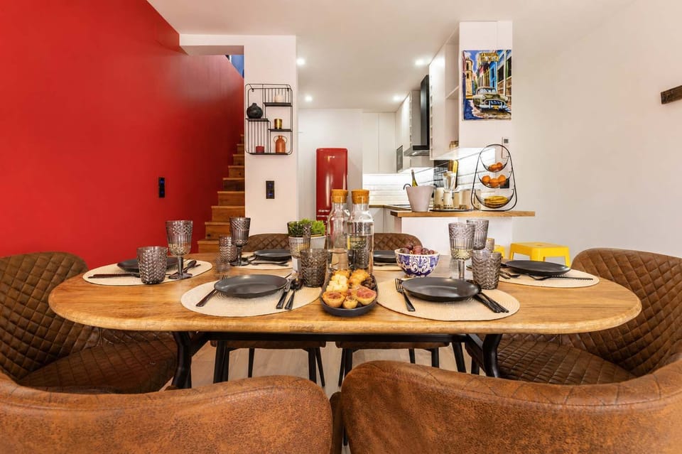 9 · Fully set dining table with staircase and kitchen views · StayInLisbon