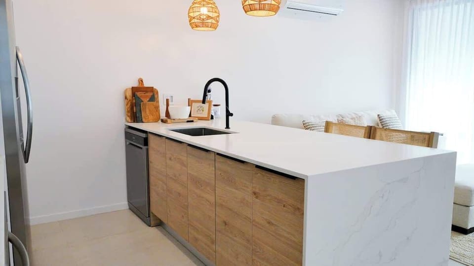 Kitchen: Open-concept living area with modern Caribbean flair, perfect for gatherings