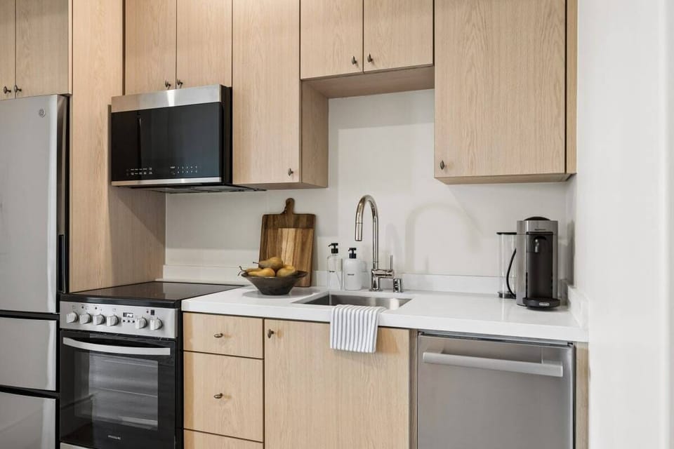 Full kitchen: Nespresso, fridge, stove/oven, plates and utensils, dishwasher