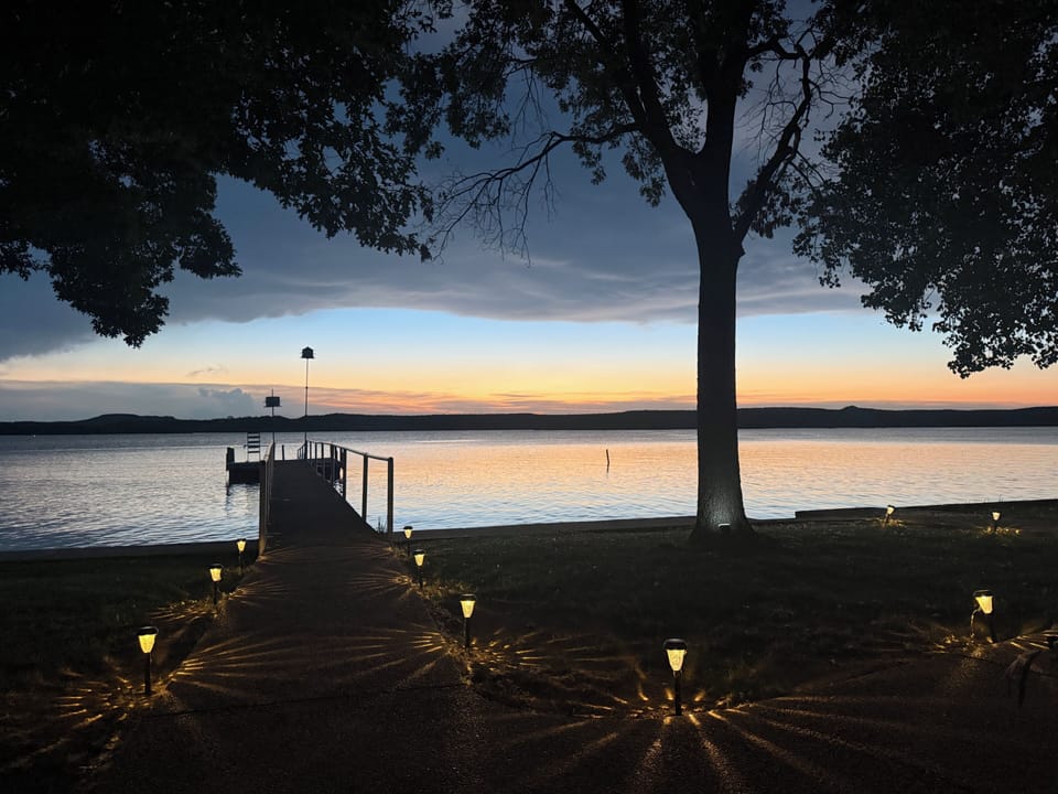 Peaceful lakefront views with a private fishing pier and swim platform. 
