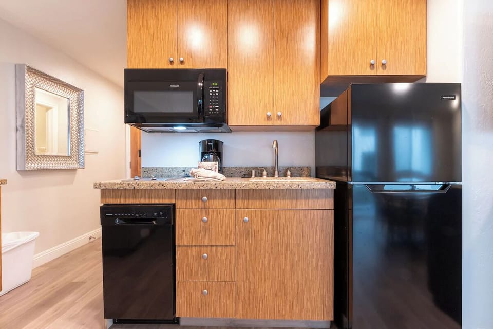 Prep simple snacks easily with fridge, microwave, and sink.