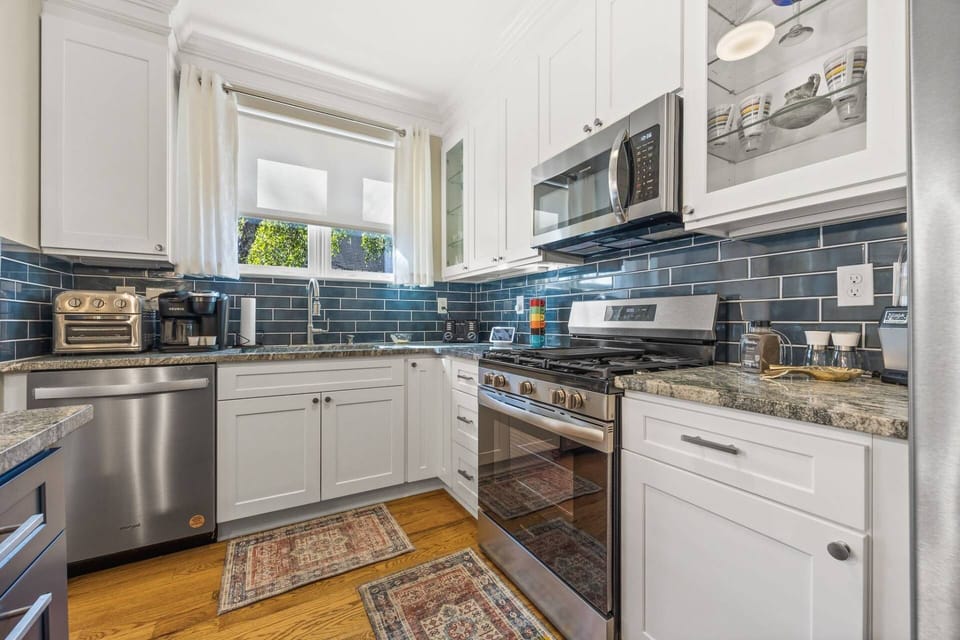 Cook with ease in the modern kitchen featuring stainless steel appliances, granite countertops, and everything needed for meals at home.
