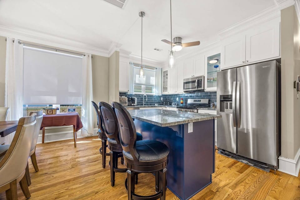 Cook with ease in the modern kitchen featuring stainless steel appliances, granite countertops, and everything needed for meals at home.