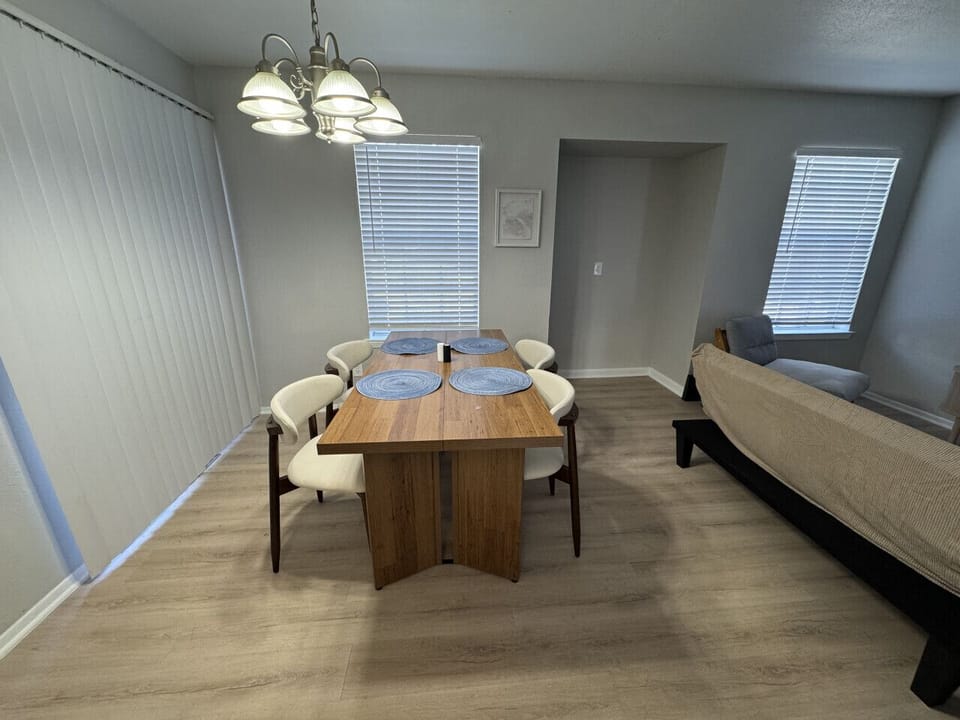 Elegant dining space with a wooden table set for a cozy meal.