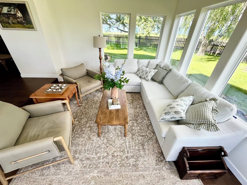 The sun room is the perfect place to cozy up while taking in the views.