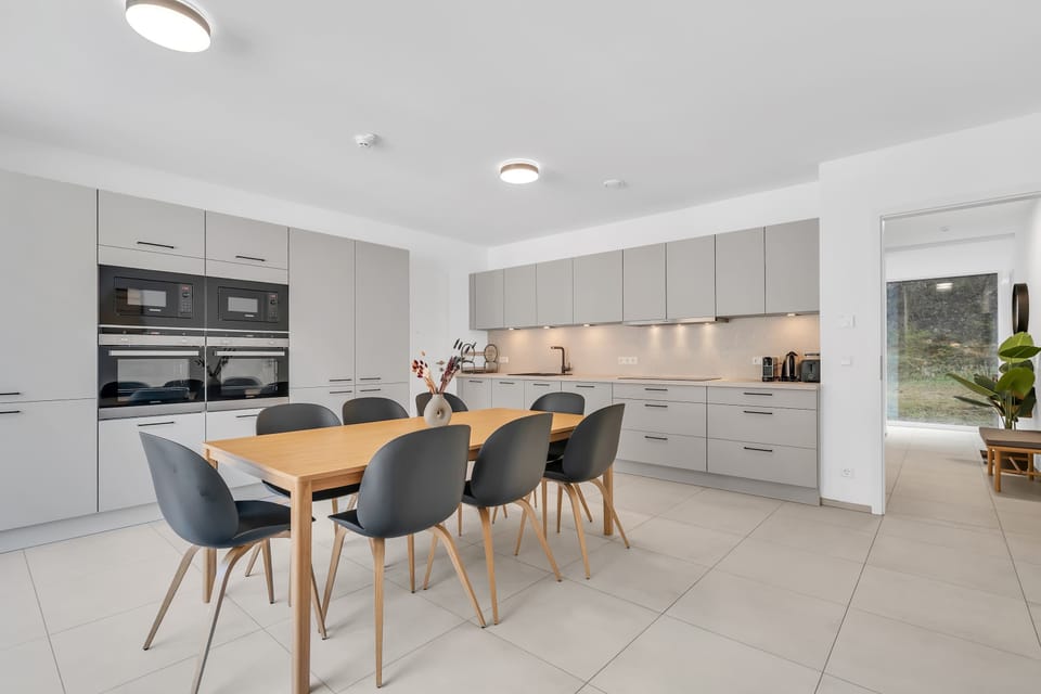 Open dining and kitchen area with modern finishes, natural light, and everything needed for easy meals during your stay