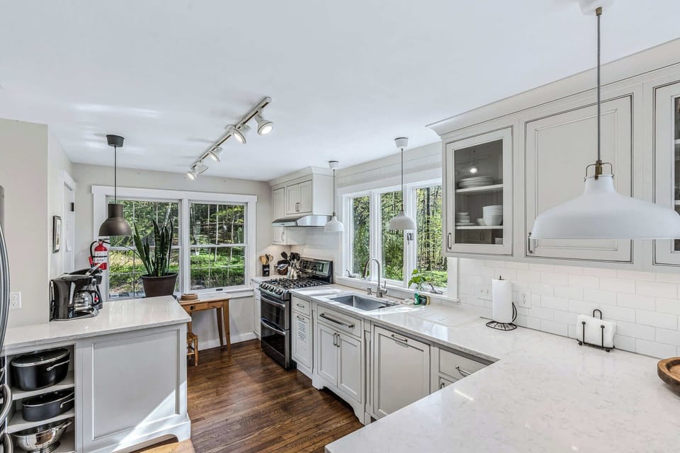 Fully equipped kitchen with gas range, dual countertops, and coffee station