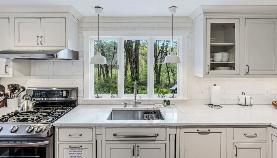 Kitchen window area with ample counter space and cabinetry