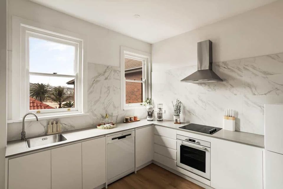 Kitchen: Modern elegance meets functionality with bright windows and sleek amenities!
