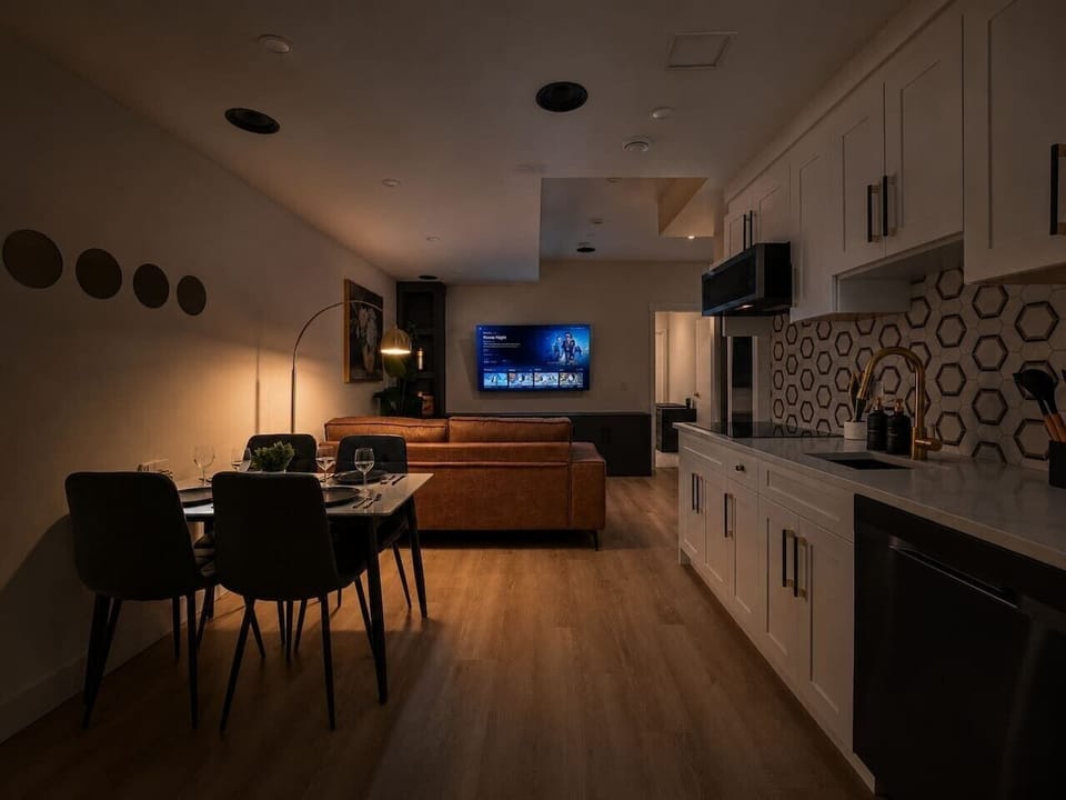 Modern open-concept kitchen, dining area, and comfortable living room