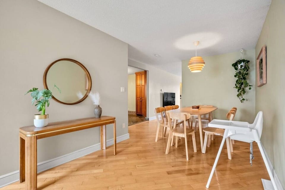 Spacious dining room with wooden table seating for six guests
