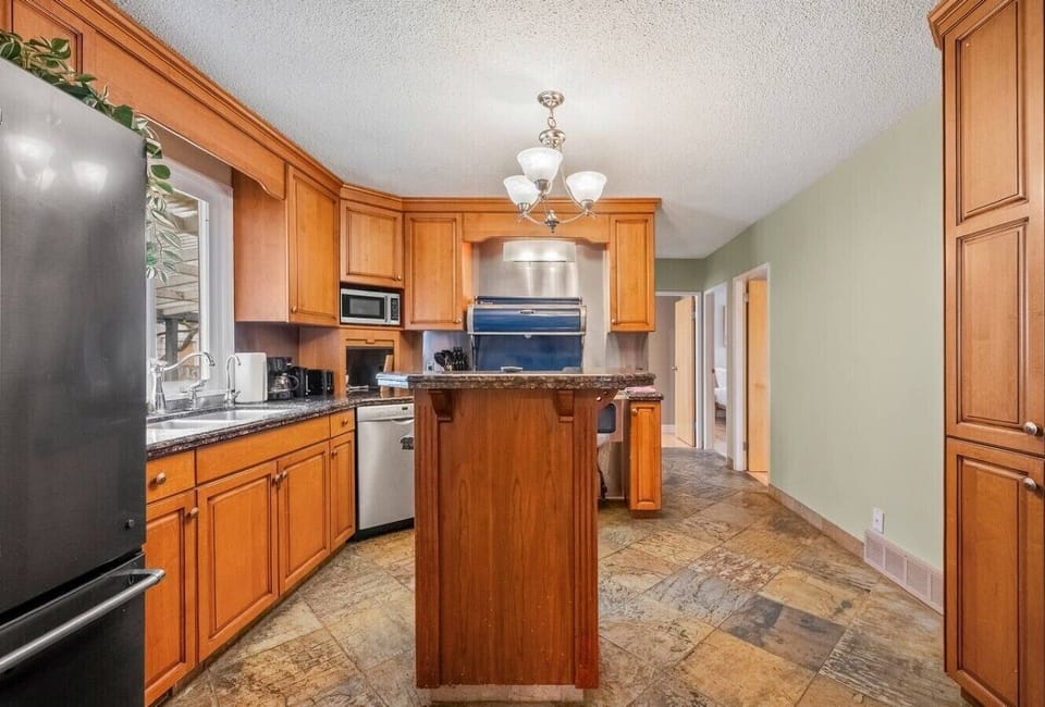 Full kitchen featuring wood cabinets, stainless steel appliances, and island