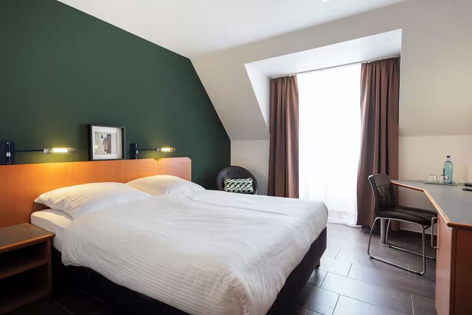 Settle in with sunshine, a cozy bed, and workspace.