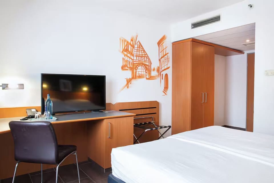 Settle in with in-room TV and a handy work desk.