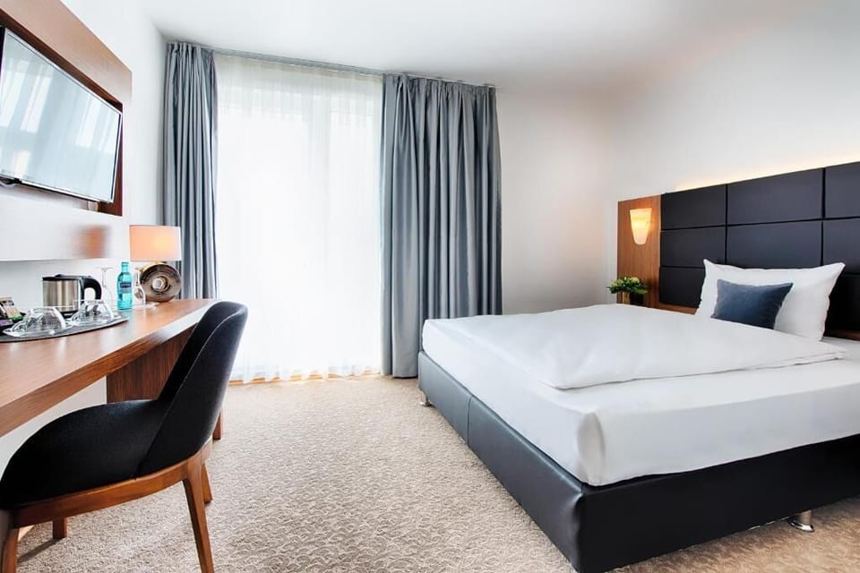 Unwind in a bright, modern room with plush bedding.