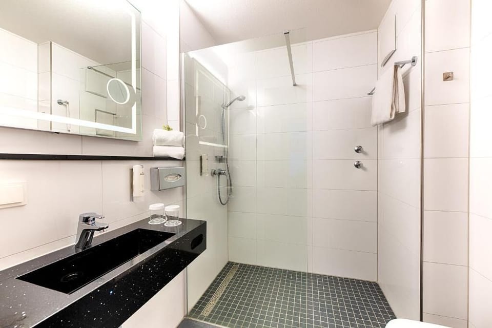 Refresh in a sleek walk-in shower with sparkling finishes.