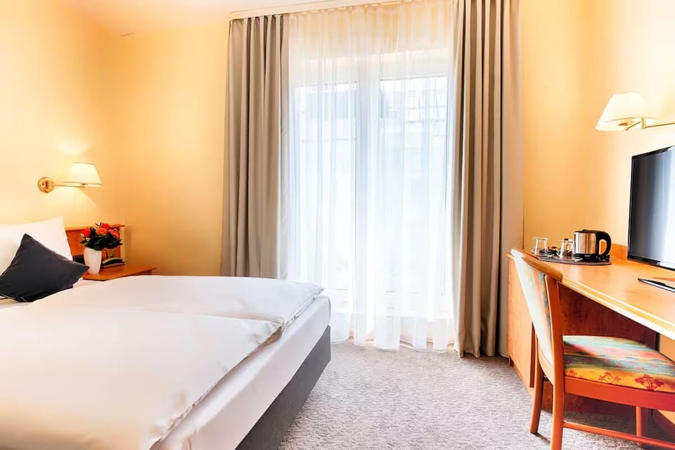 Wake up to soft daylight filtering through floor-to-ceiling curtains.