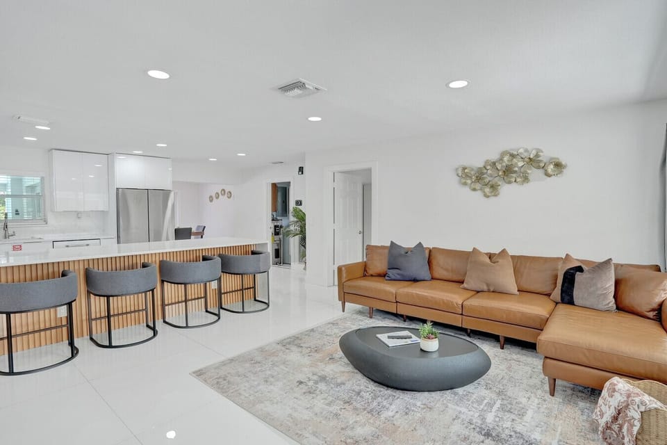 Bright modern living room flowing into a spacious kitchen island with comfortable seating