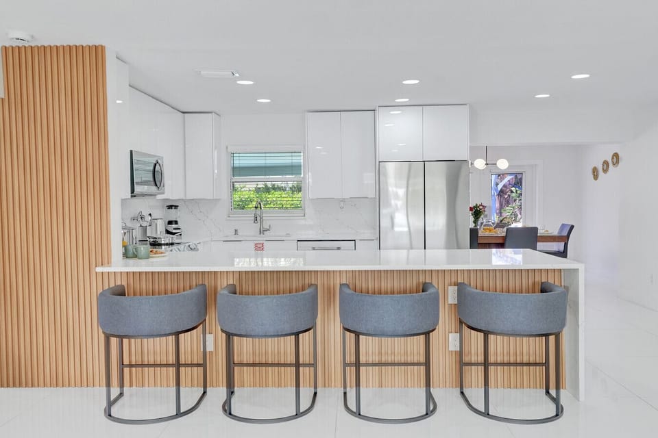 Bright, modern kitchen featuring a spacious island with comfortable seating
