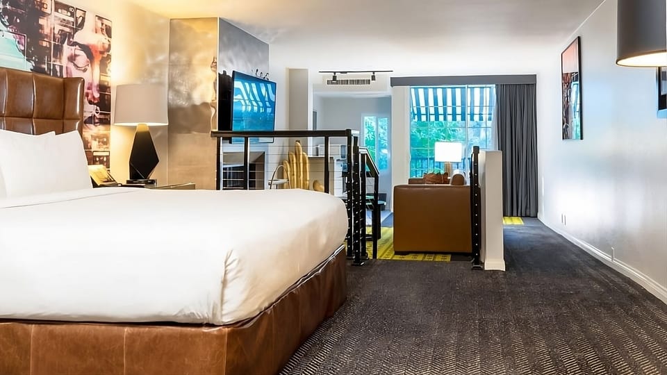 Unwind in a plush bed with open-plan lounge beyond.