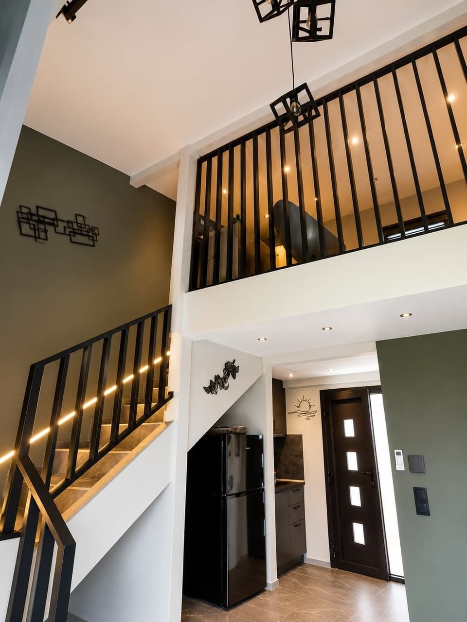 Unique architectural design with stylish staircase and open gallery overlooking the living area.