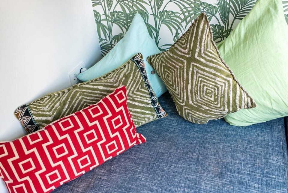 Layered cushions invite slow afternoons by the window.