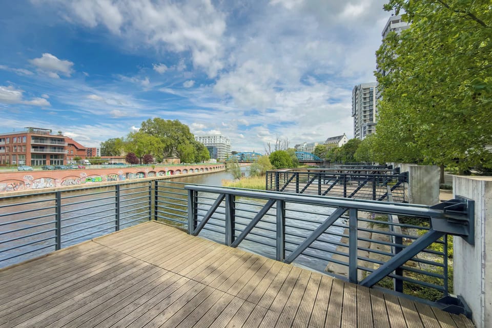A riverside or walkway view near the property. The area looks peaceful and ideal for walks.