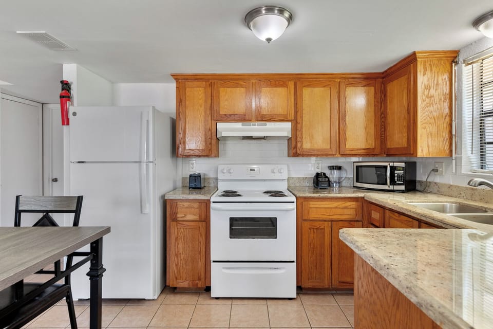 Fully equipped kitchen with granite countertops, full-size appliances, and all the essentials for preparing meals