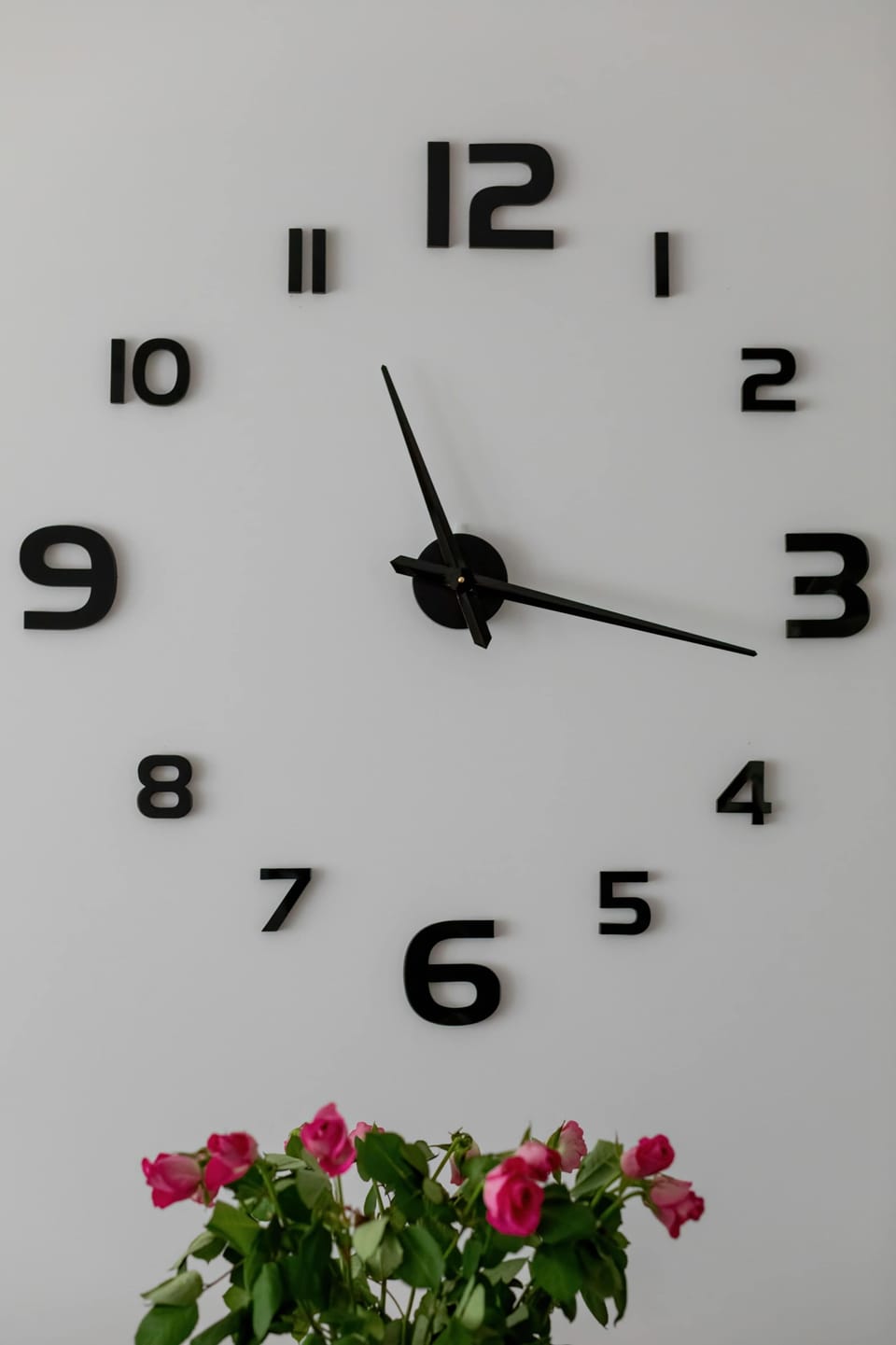 Modern wall clock detail above dining table
