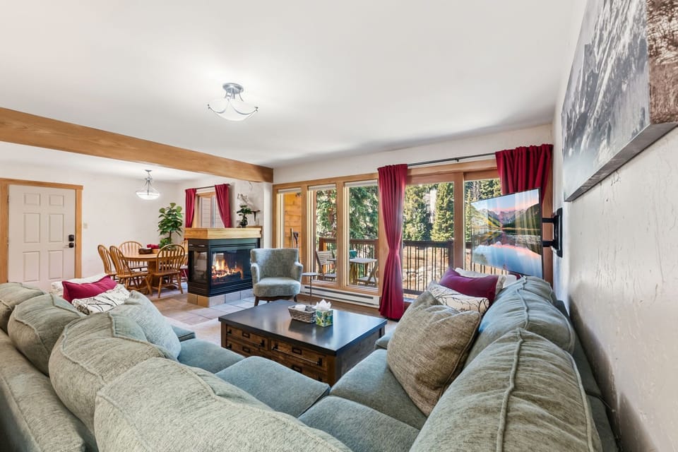 Sink into plush sofas by the fireplace and enjoy mountain views through large windows. A perfect retreat after exploring the outdoors.