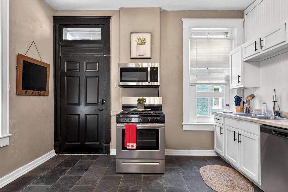 Kitchen: Bright, functional kitchen featuring a full-size stove, refrigerator, microwave, and well-stocked cabinets that make cooking feel easy and enjoyable