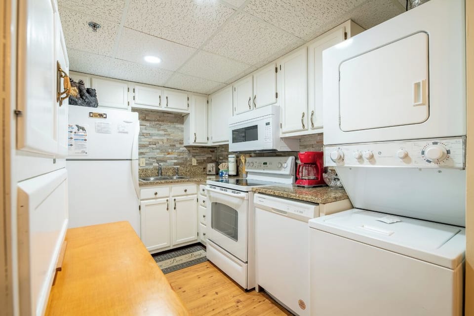 Your fully-equipped kitchen awaits with everything you need for your stay—stove, microwave, fridge, and in-unit washer and dryer for ultimate convenience and comfort.