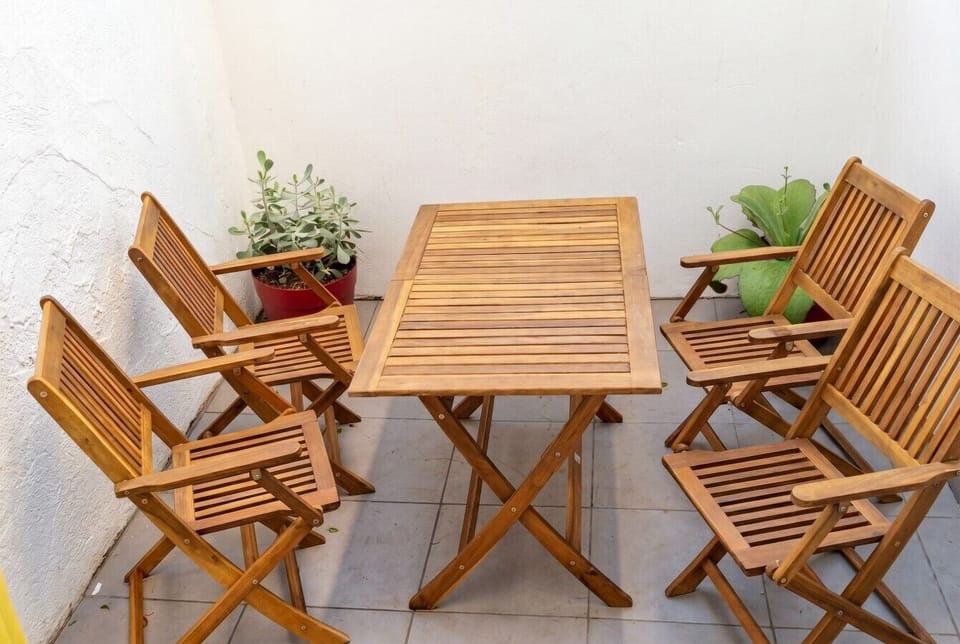 Solid wood patio set waiting for morning coffee outdoors.
