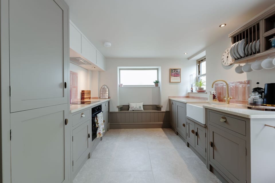 A fully equipped kitchen includes a dishwasher and washing machine for your convenience