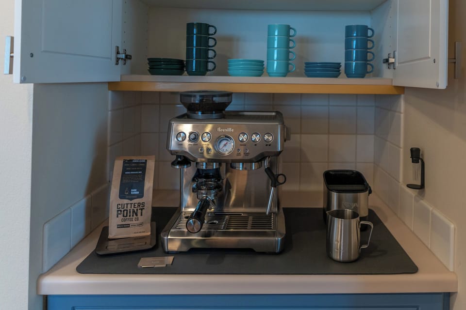 Your morning coffee bar, featuring a high-end Breville espresso machine, grinder, and local coffee beans to start your day right.