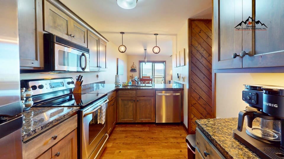 Step into your fully-equipped mountain kitchen, where granite counters, stainless appliances, and warm wood cabinetry invite you to whip up everything from morning coffee to hearty après-ski meals.